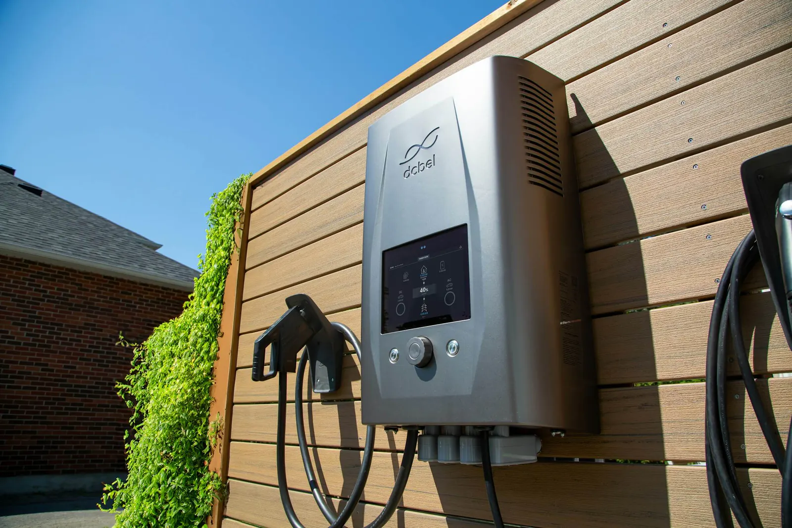 Wall-mounted electric vehicle charger outside a home