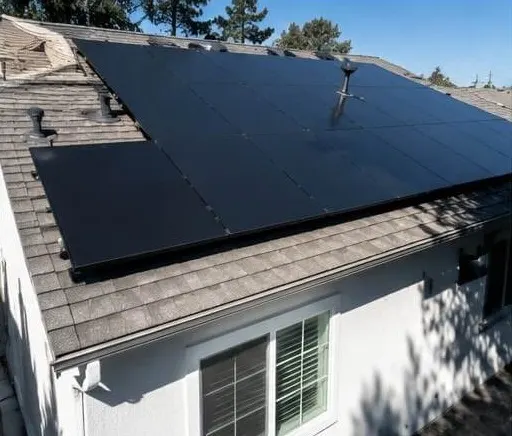 All-black solar panels on a shingle roof
