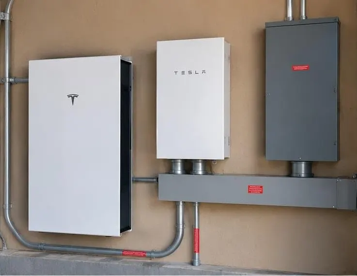 Home battery and backup gateway mounted on a garage wall