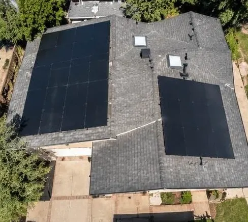 Aerial view of a rooftop solar system on two roof planes